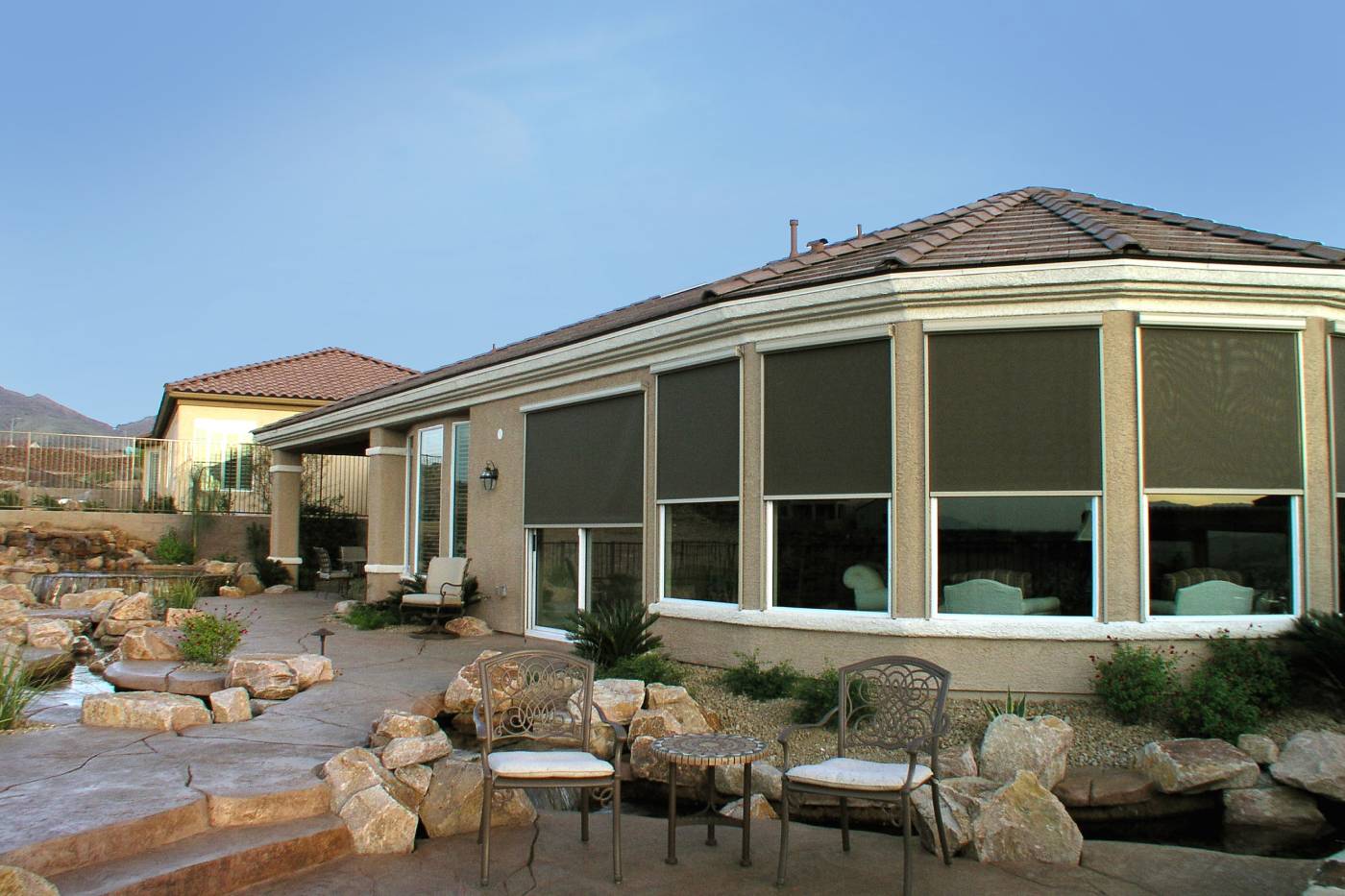 Modern house with exterior window shades covering bay windows