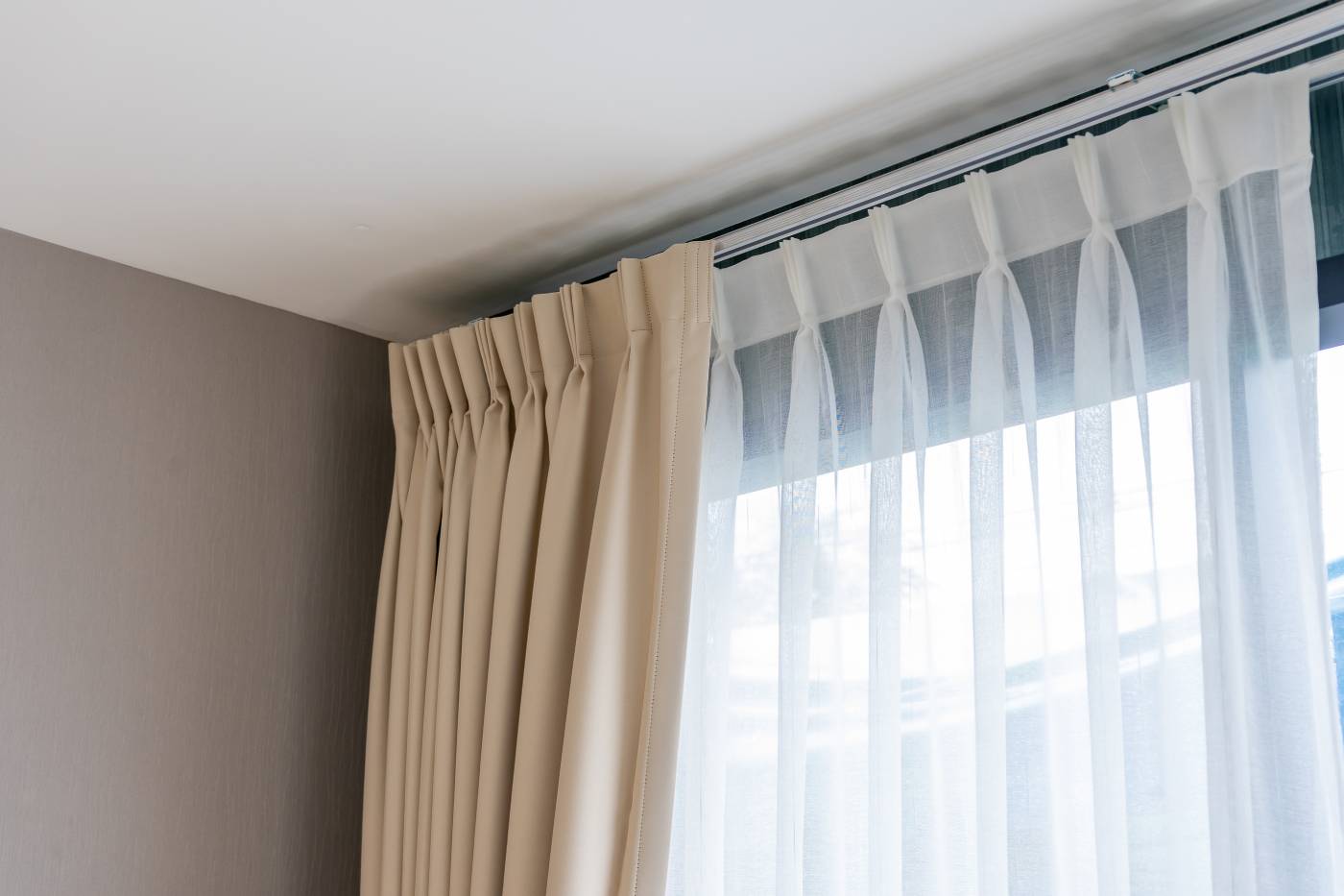 Custom drapery with a liner covering a large window in a home near Huntington Beach, CA