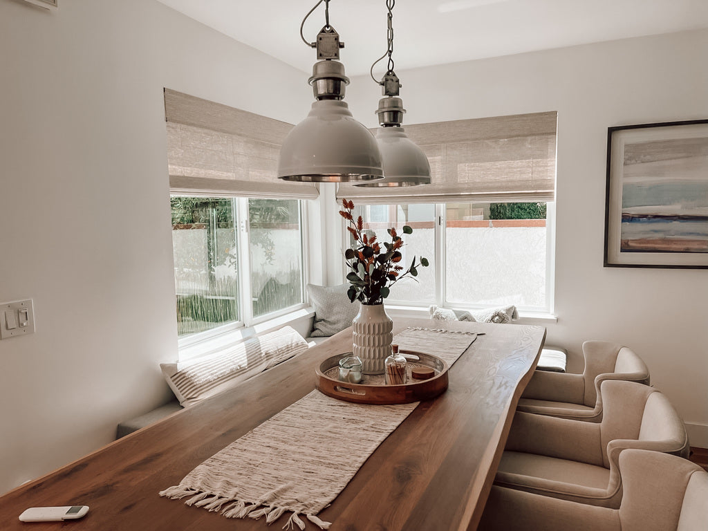 Dining room with motorized woven wood window treatments helps finish this beautiful space in Costa Mesa, CA.
